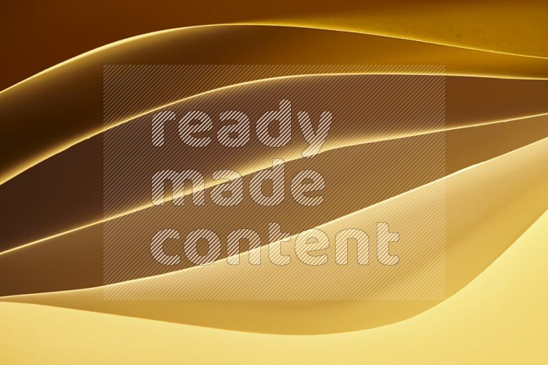 This image showcases an abstract paper art composition with paper curves in gold gradients created by colored light