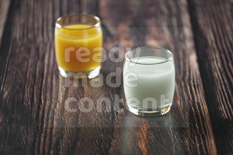 Cold drinks in a glass cup such as water, tamarind, qamar eldin, sobia, milk and hibiscus on wooden background