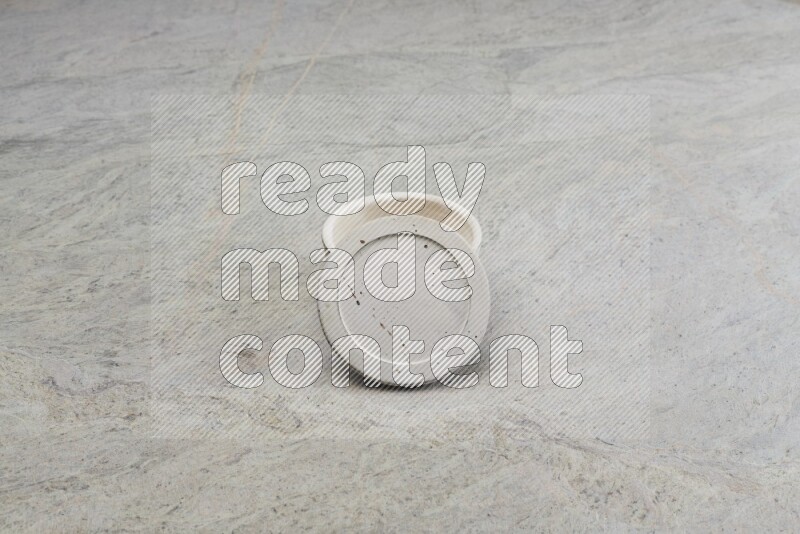 A white pottery bowl on grey marble background
