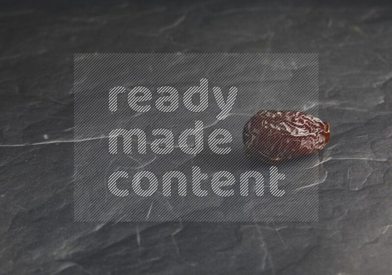 one madjoul date on a black textured background
