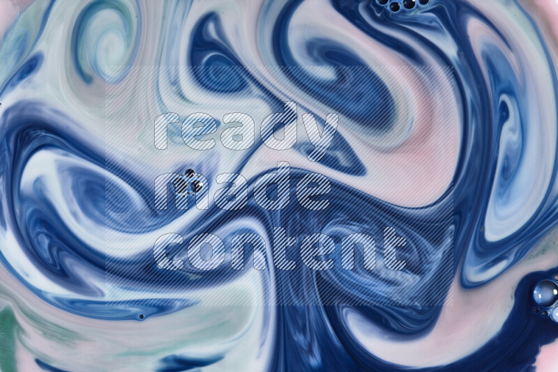 A close-up of abstract swirling patterns in red, green, white and blue