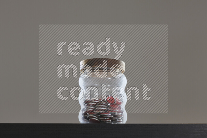 Buttons in a glass jar on black background