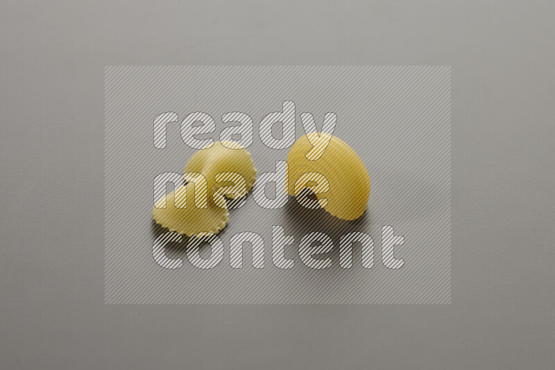 Fiocchi pasta with other types of pasta on grey background