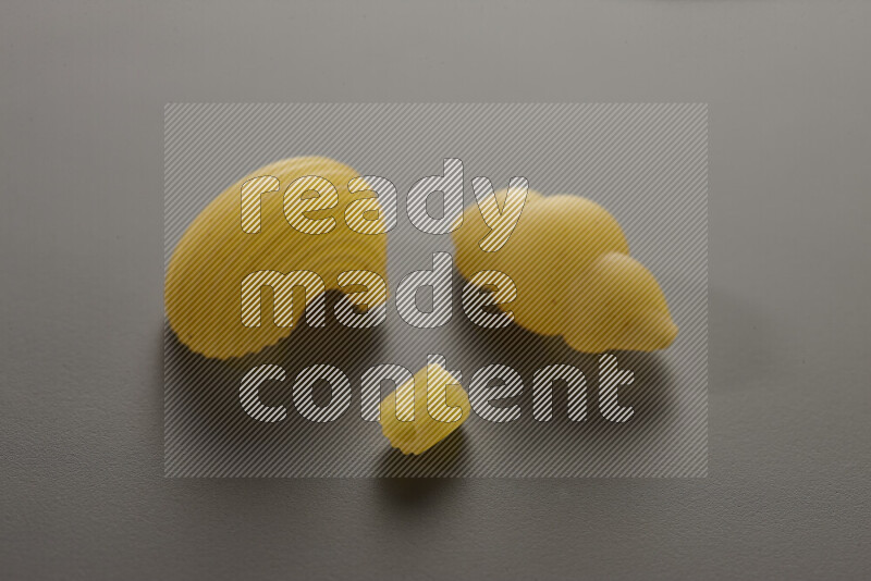 Different pasta types on grey background
