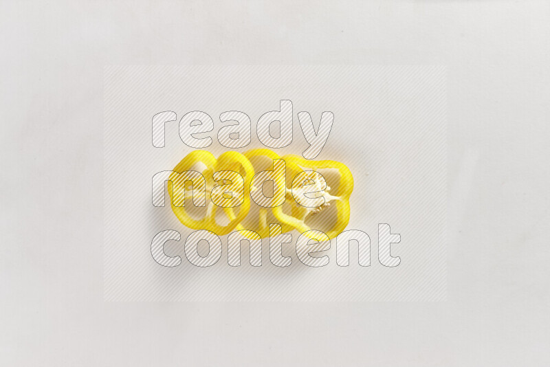 Yellow bell pepper slices on white background