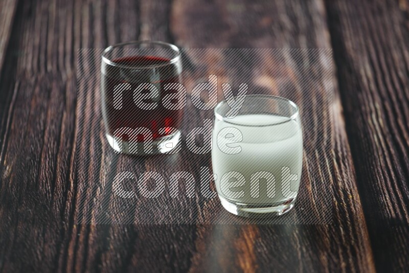 Cold drinks in a glass cup such as water, tamarind, qamar eldin, sobia, milk and hibiscus on wooden background