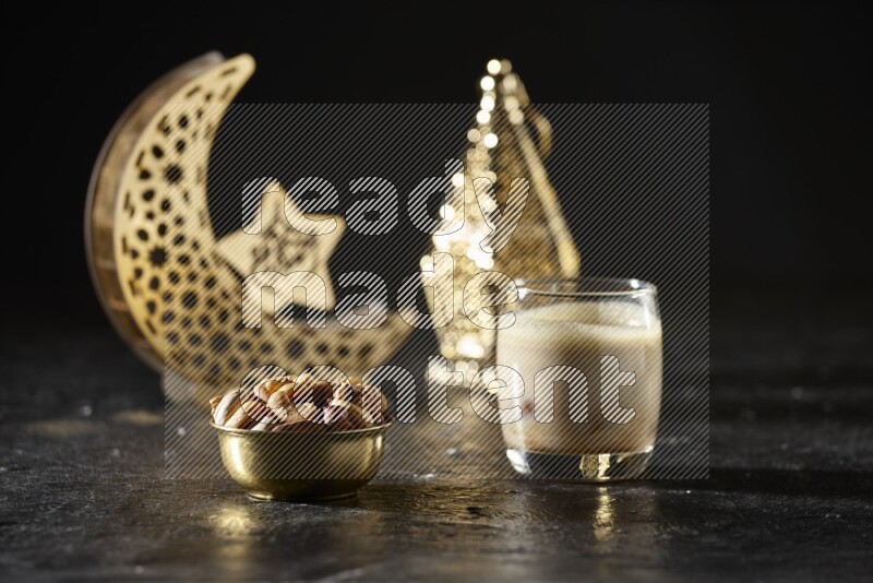 Nuts in a metal bowl with Nuts smoothie beside golden lanterns in a dark setup