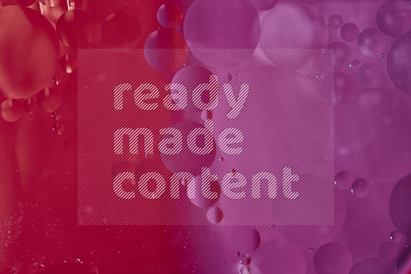 Close-ups of abstract oil bubbles on water surface in shades of red and pink