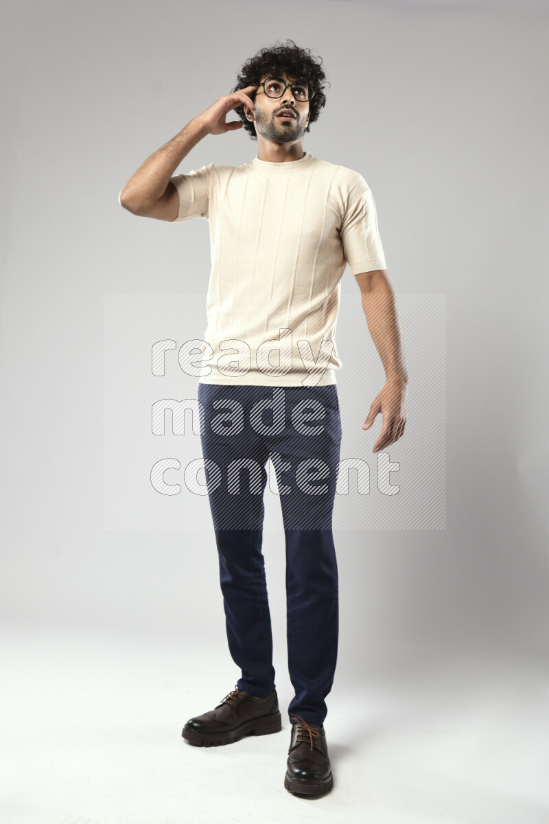 A man wearing casual standing and making a hand gesture on white background