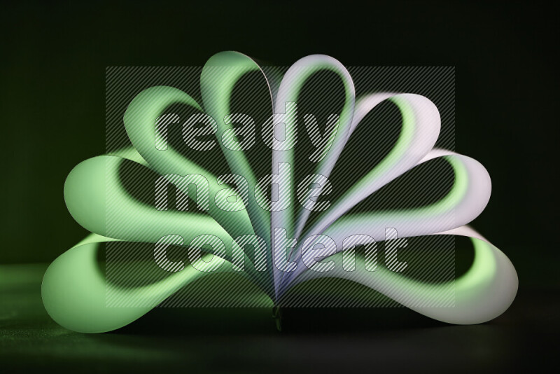 An abstract art piece displaying smooth curves in green and white gradients created by colored light