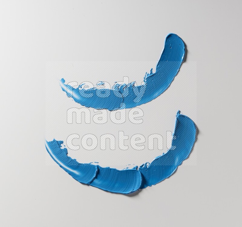 Blue curved painting knife strokes on white background