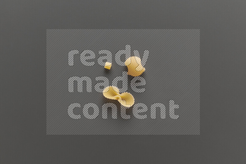 Different pasta types on grey background