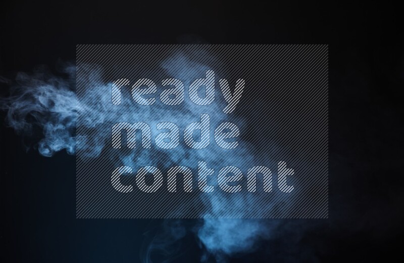 Heavy smoke in blue isolated on black background