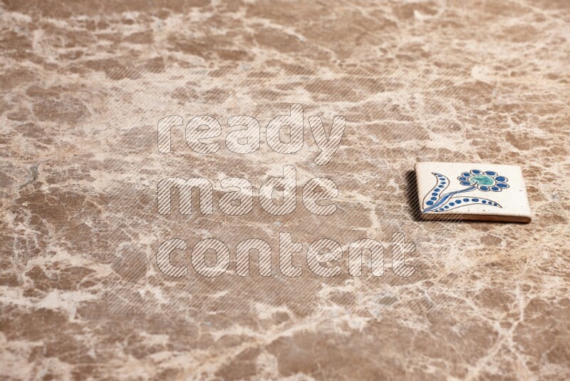 A decorative coaster on beige marble background