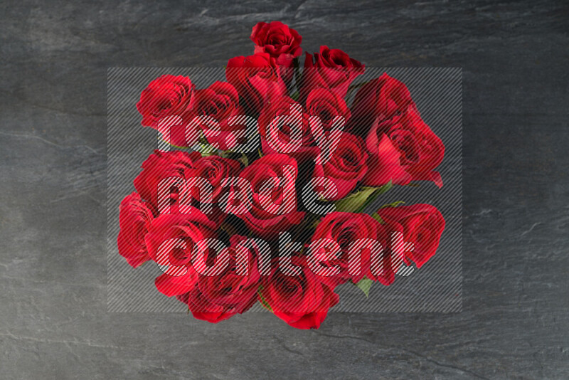A luxurious bouquet of red roses on black marble background