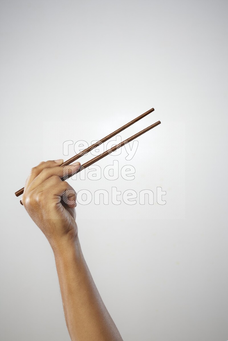 Male Hand Holding Chop Stick on white background