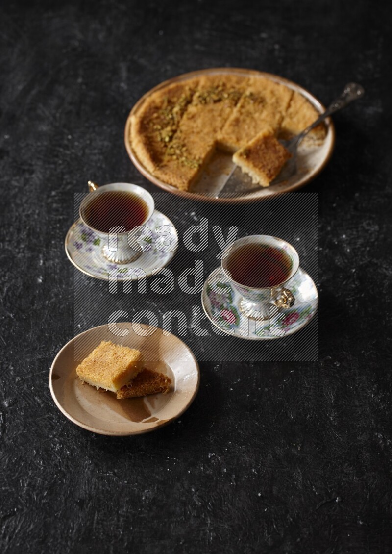 konafa with tea in a dark setup