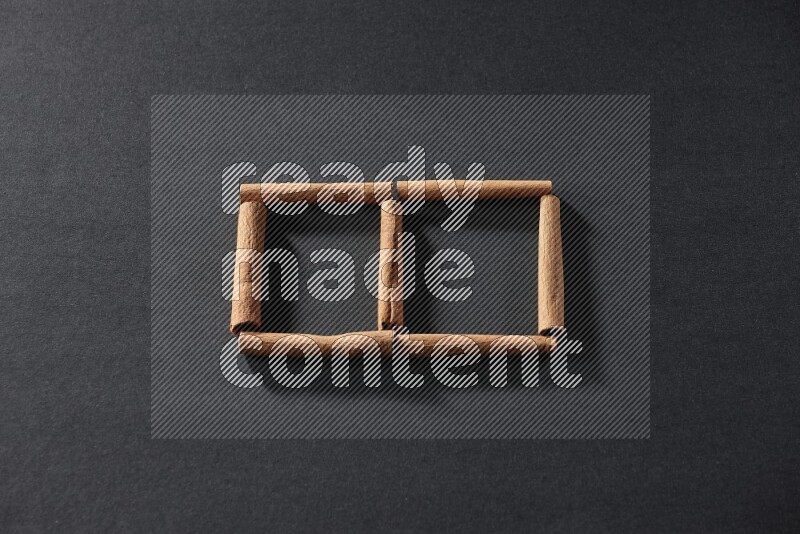 2 squares of cinnamon sticks on black flooring