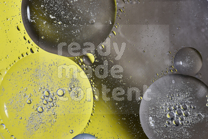 Close-ups of abstract oil bubbles on water surface in shades of yellow and brown