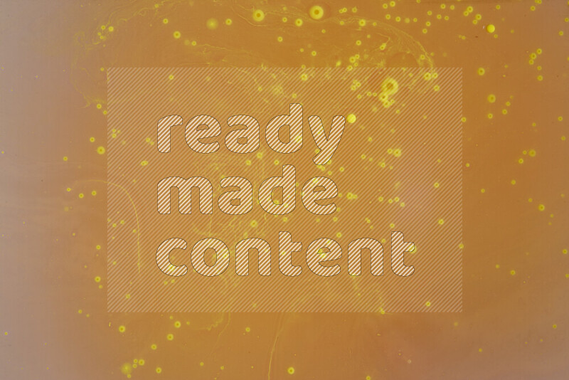 The image captures a dramatic splatter of yellow paint over a white backdrop