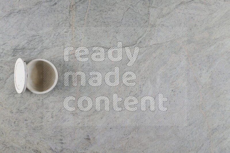 A multicolored pottery Cup on grey marble background
