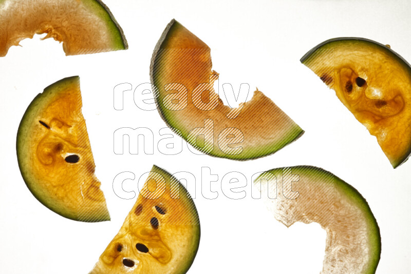 Mixed fruits slices on illuminated white background