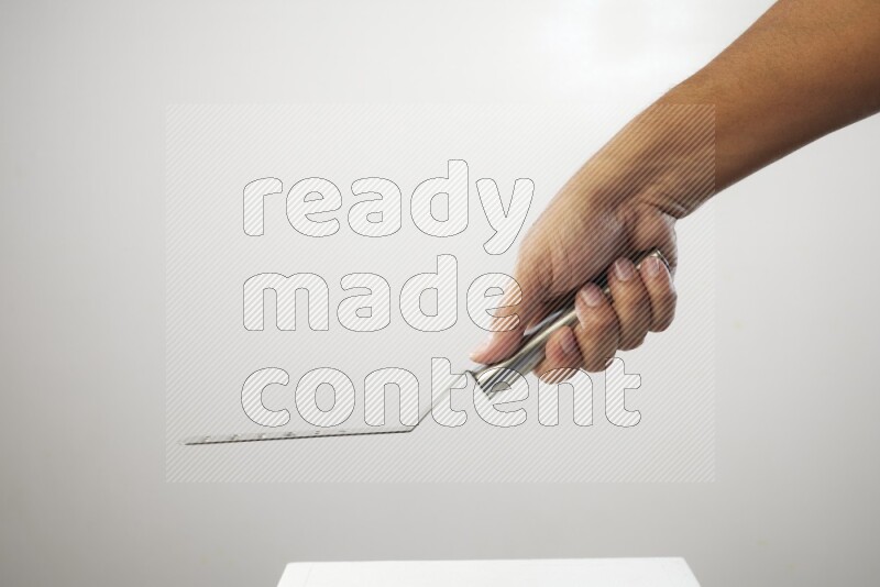 Male Hand Holding Burger Flipper on white background