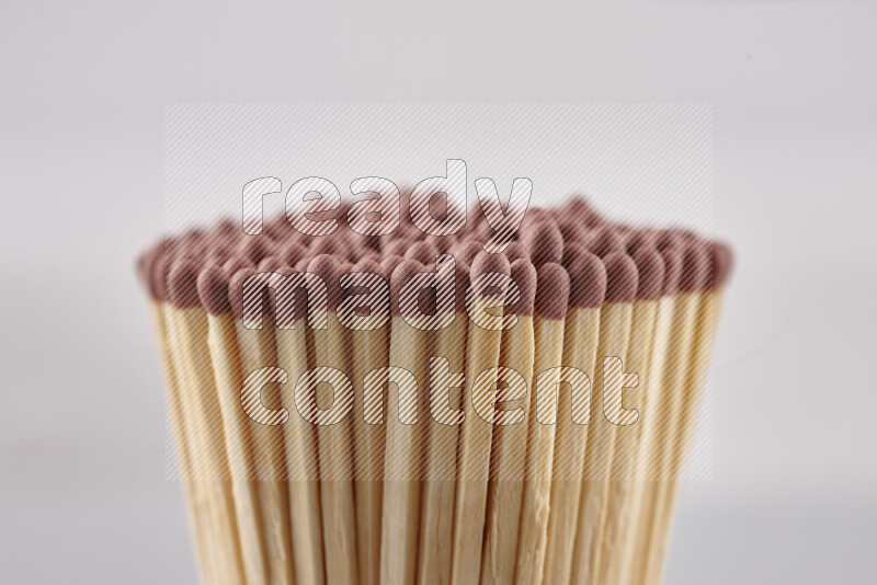 A close-up of a bundle of matches on grey background