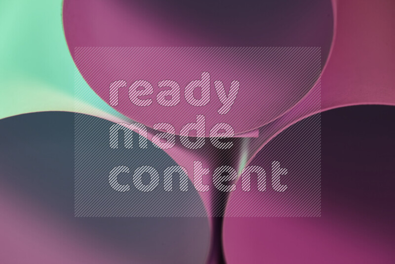 The image shows an abstract paper art with circular shapes in varying shades of green and pink