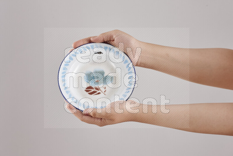Woman hands holding different metal essentials in different positions