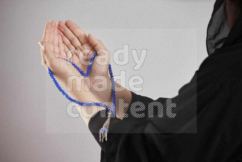 Woman hands holding praying beads (sebha) in different positions