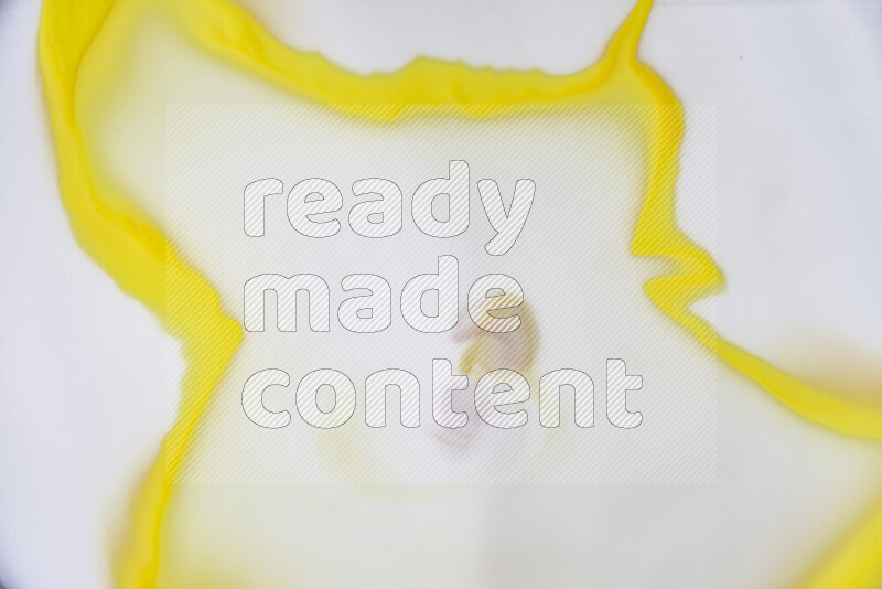 A close-up of abstract swirling patterns in yellow and white