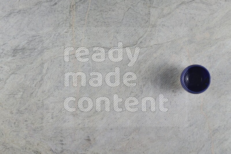 A multicolored pottery Cup on grey marble background