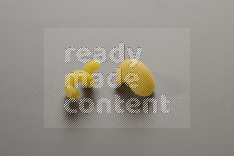 Twist pasta with other types of pasta on grey background