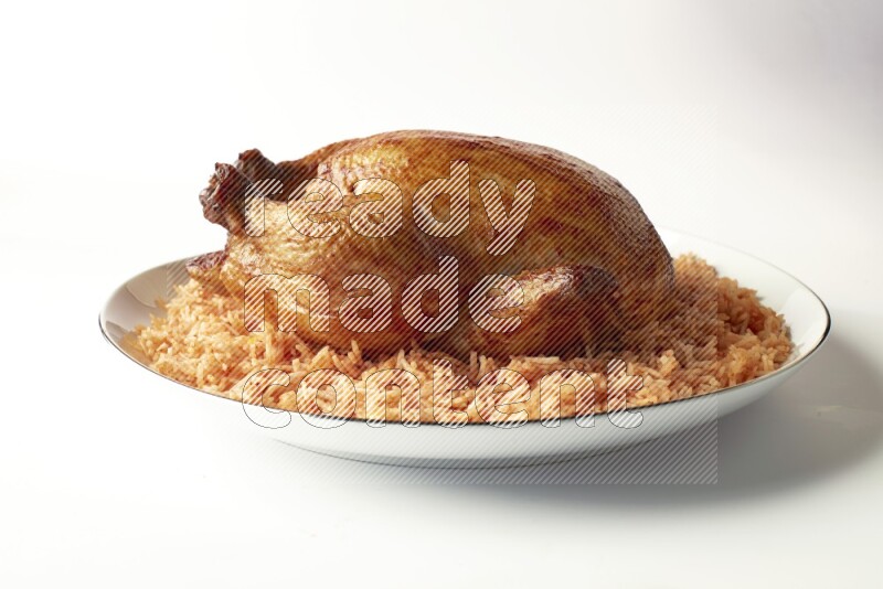 red basmati Rice with whole roasted chicken on a white plate with a silver rim direct on white background