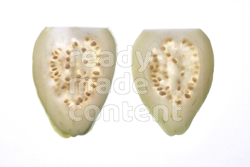Guava slices on illuminated white background