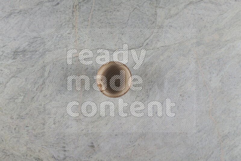 A multicolored pottery Cup on grey marble background