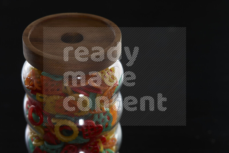 Snacks in a glass jar on black background