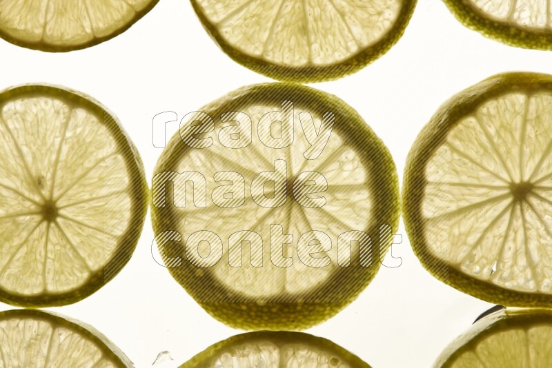 Lemon slices on illuminated white background