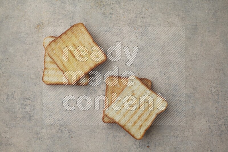 Toasted white Toast slices on a light blue textured background