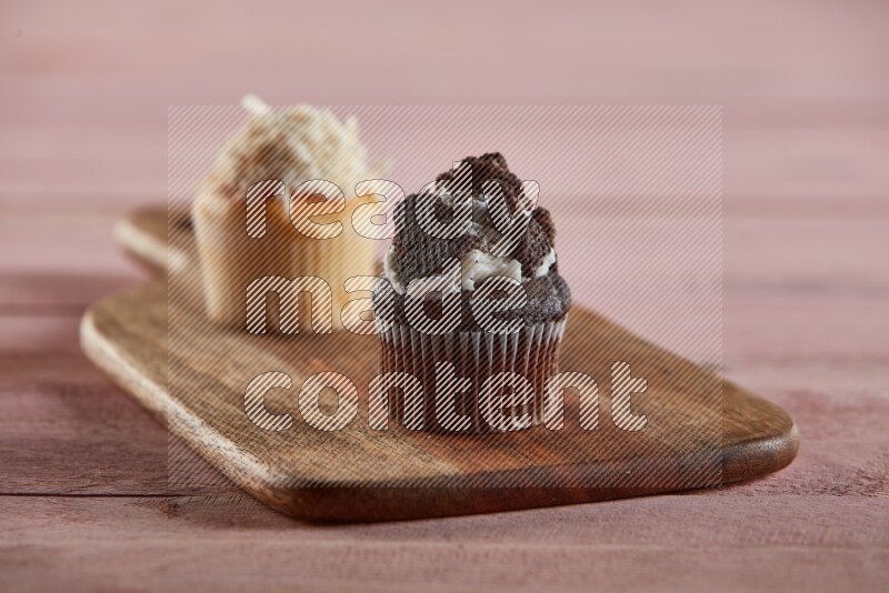 Chocolate mini cupcake topped with oreo on a wooden board