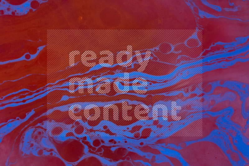 The image depicts a marbling effect with swirling patterns of red and blue