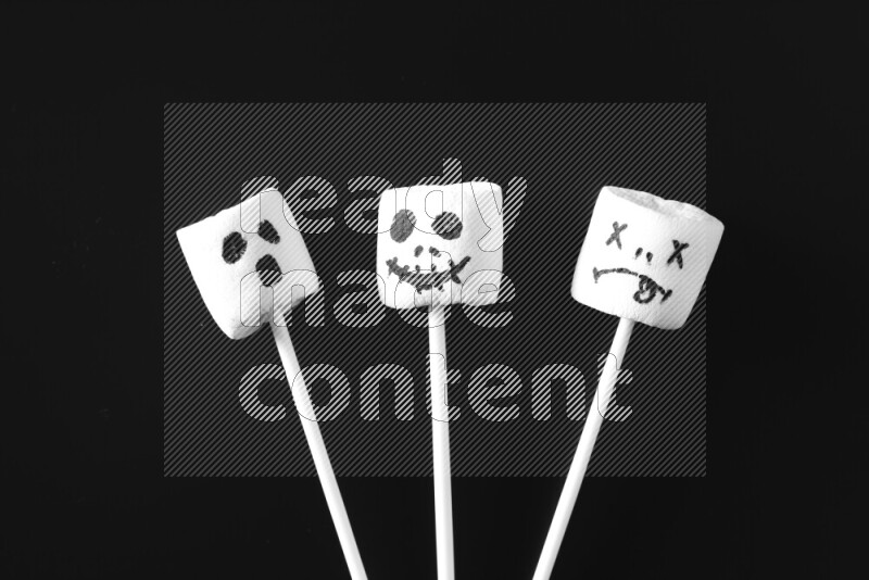 Halloween shapes on marshmallows on black background