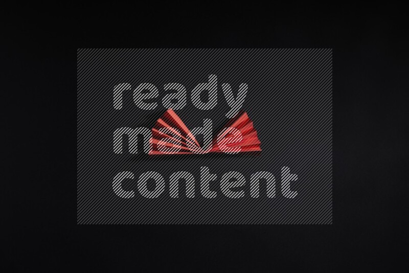 Red paper sheet on black background