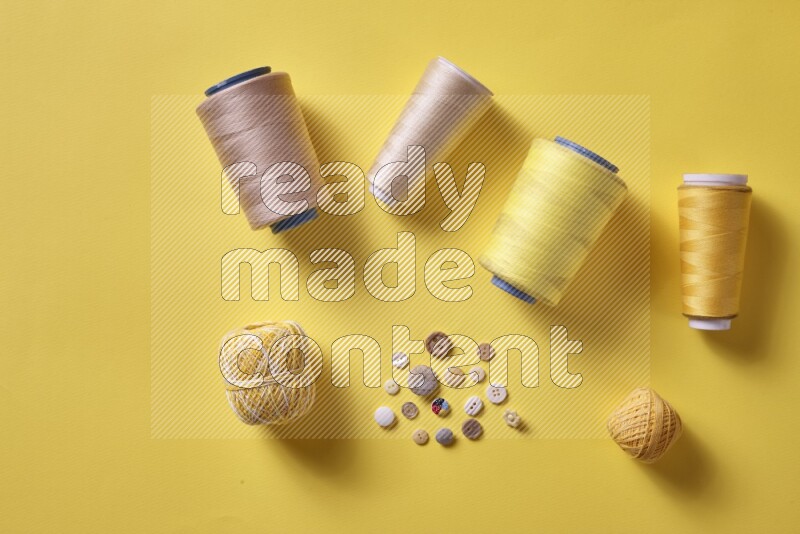 A yellow collection of sewing and tailoring tools arranged on a yellow background