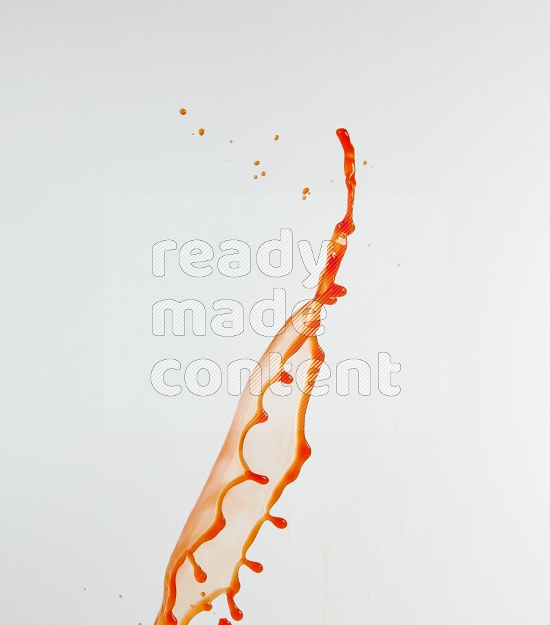 Orange liquid splash and drops on white background