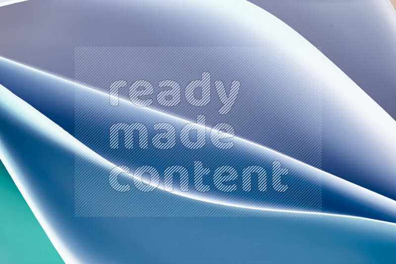 This image showcases an abstract paper art composition with paper curves in green and blue gradients created by colored light