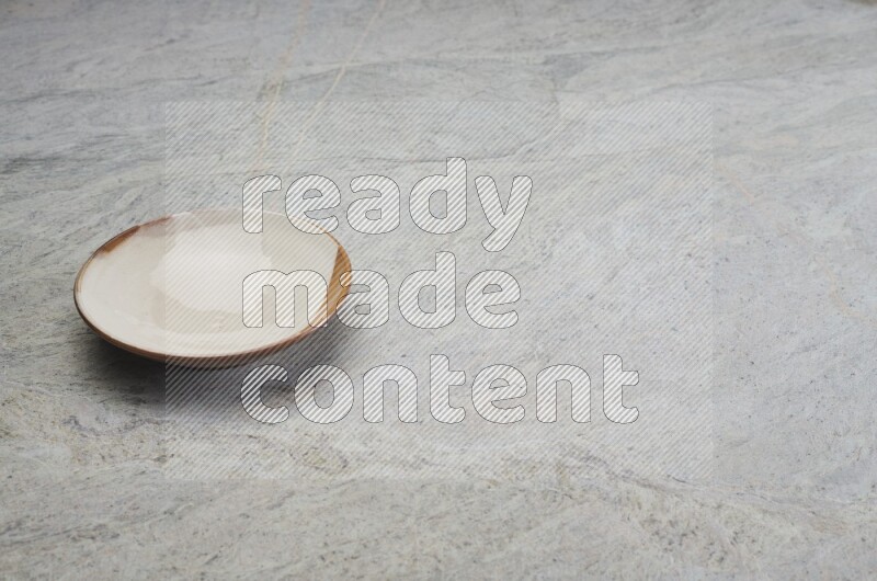Multicolored Pottery Plate On Grey Marble Flooring
