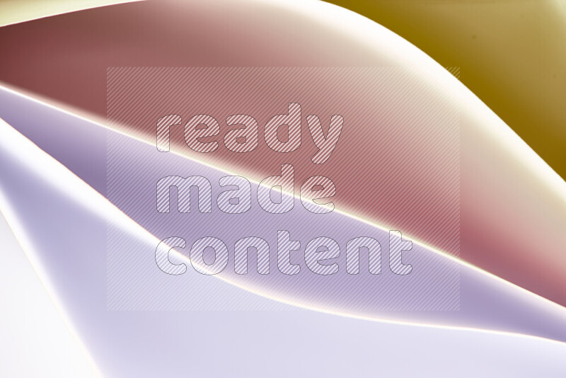 This image showcases an abstract paper art composition with paper curves in white and different warm gradients created by colored light