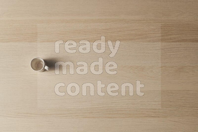 A pottery cup on light wooden background